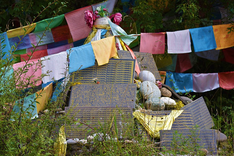 Prayer Flags and Mani Wall in Tibetan Village